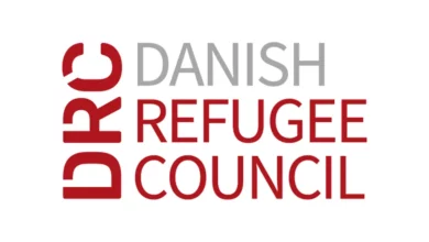 Danish Refugee Council staff supporting displaced communities in field operations through entry-level jobs 2026